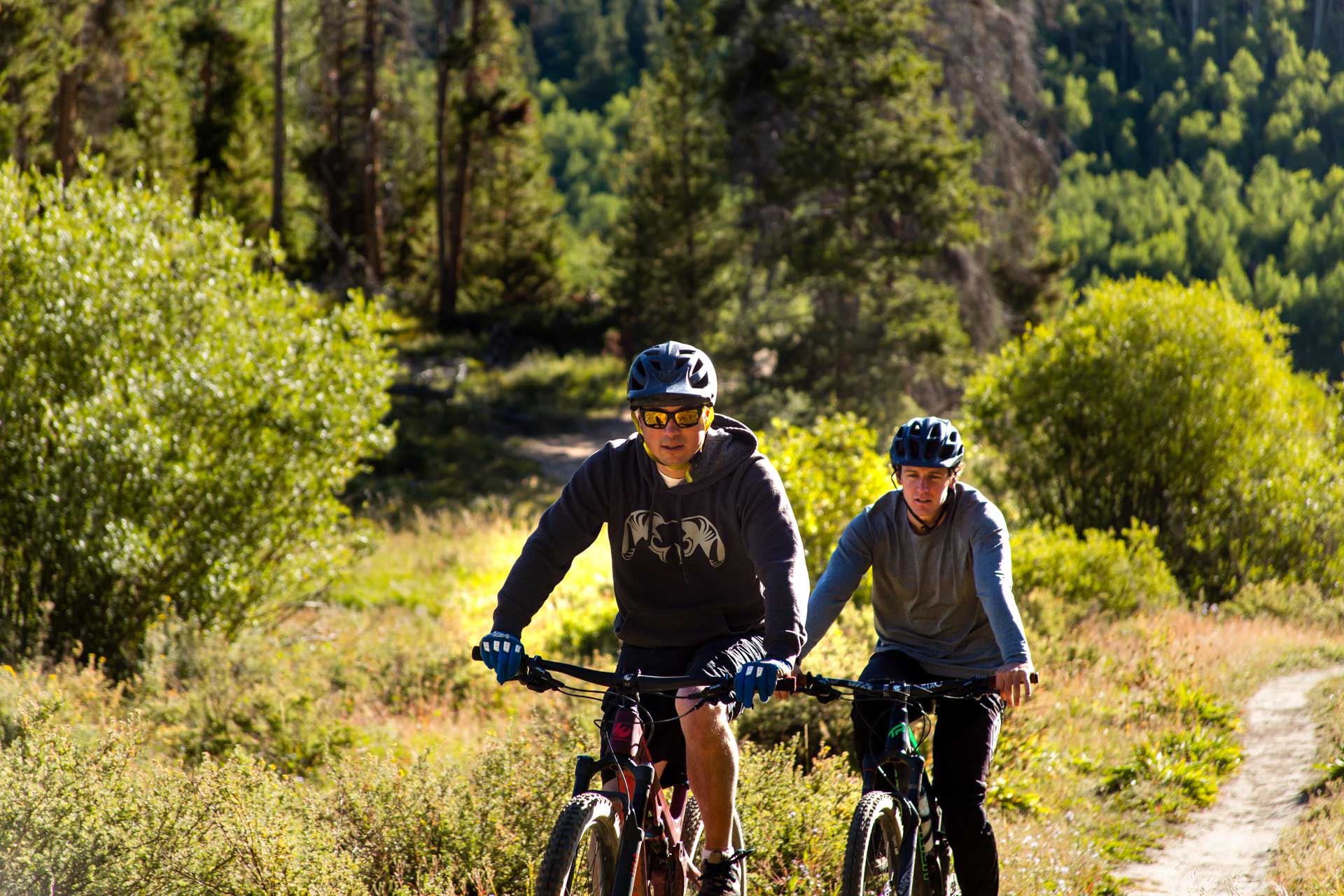 Two bikers on a trail enjoying things to do in summit county in summer