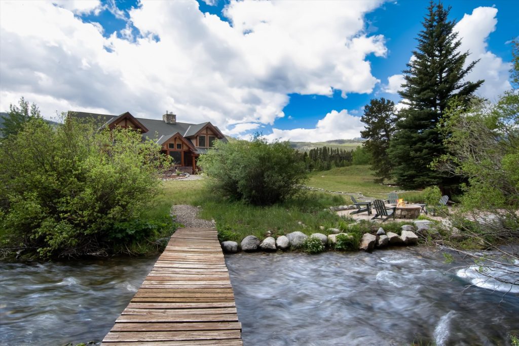 shot of a stream and bridge in a colorado home backyard cleaned up while preparing your mountain property for sale