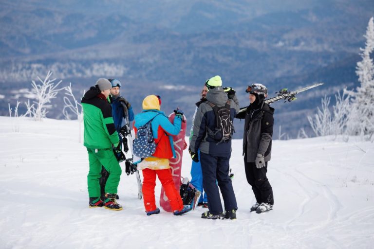 group of family members in snowsuits and skis getting ready to ski as one of the things to do in summit county in winter